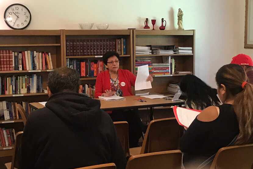 Jaquina Balli helps people applying for parish-issued ID cards fill out a survey while they...