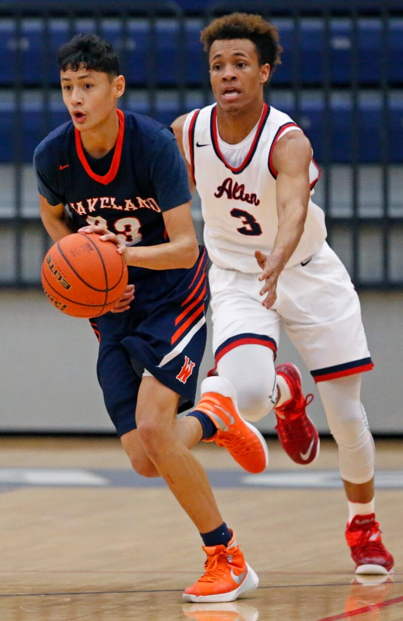 Wakeland gaurd Javante McCoy (23) dribbles the basketball past Allen gaurd Ben Dixon during...