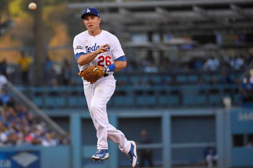 Los Angeles Dodgers' Chase Utley throws out Chicago Cubs' Miguel Montero during the second...