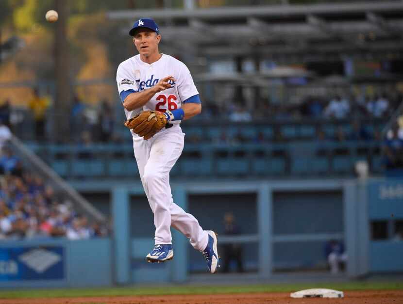 Los Angeles Dodgers' Chase Utley throws out Chicago Cubs' Miguel Montero during the second...