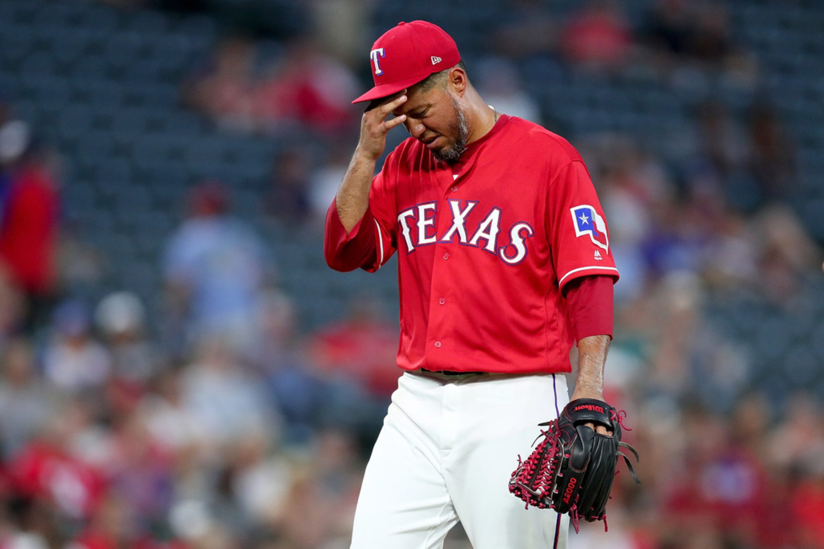 ARLINGTON, TX - AUGUST 14:  Yovani Gallardo #49 of the Texas Rangers reacts after being...