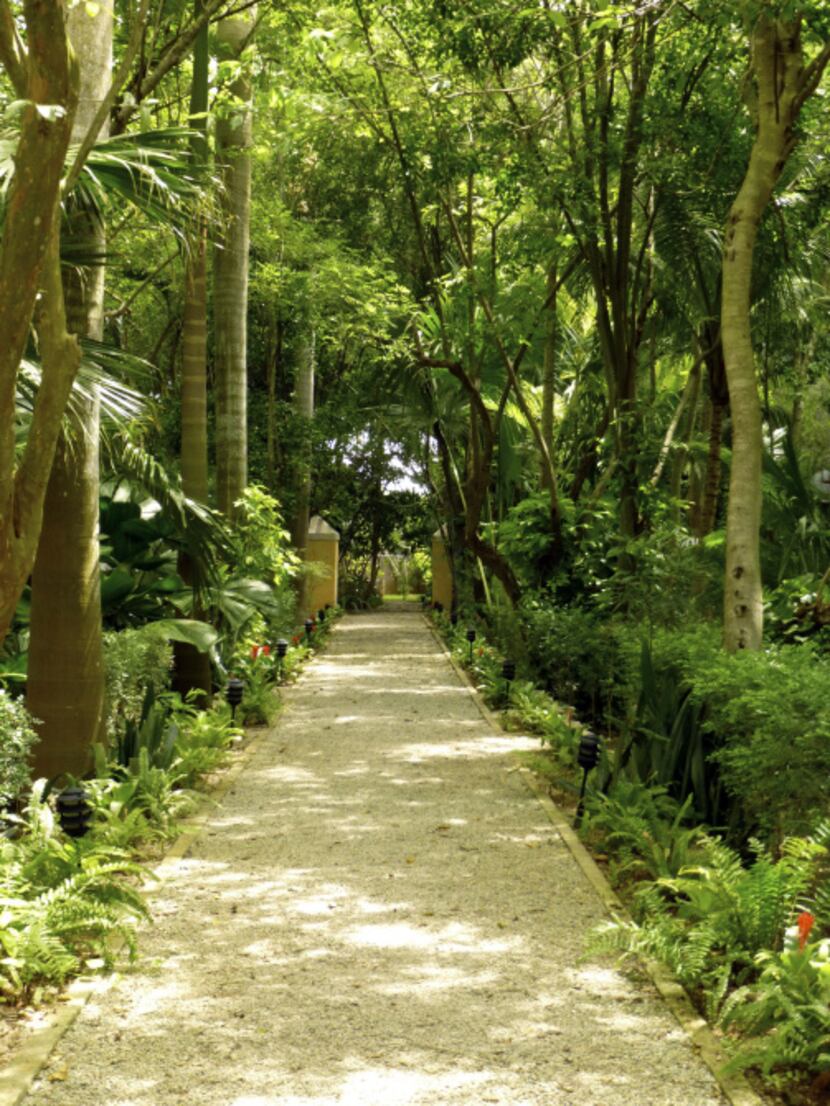 Pathways lead to surprises in the lush gardens at Hacienda Xcanatún.