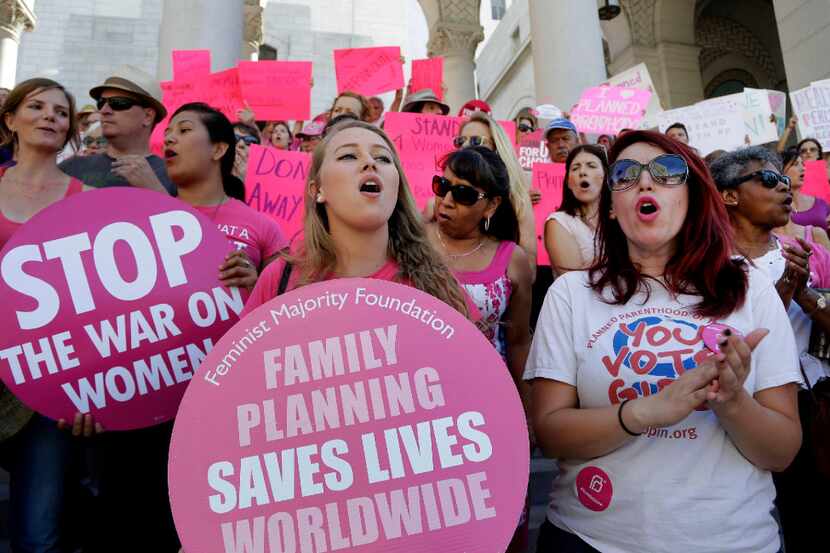In this Sept. 9, 2015, file photo, Planned Parenthood supporters rally for women's access to...