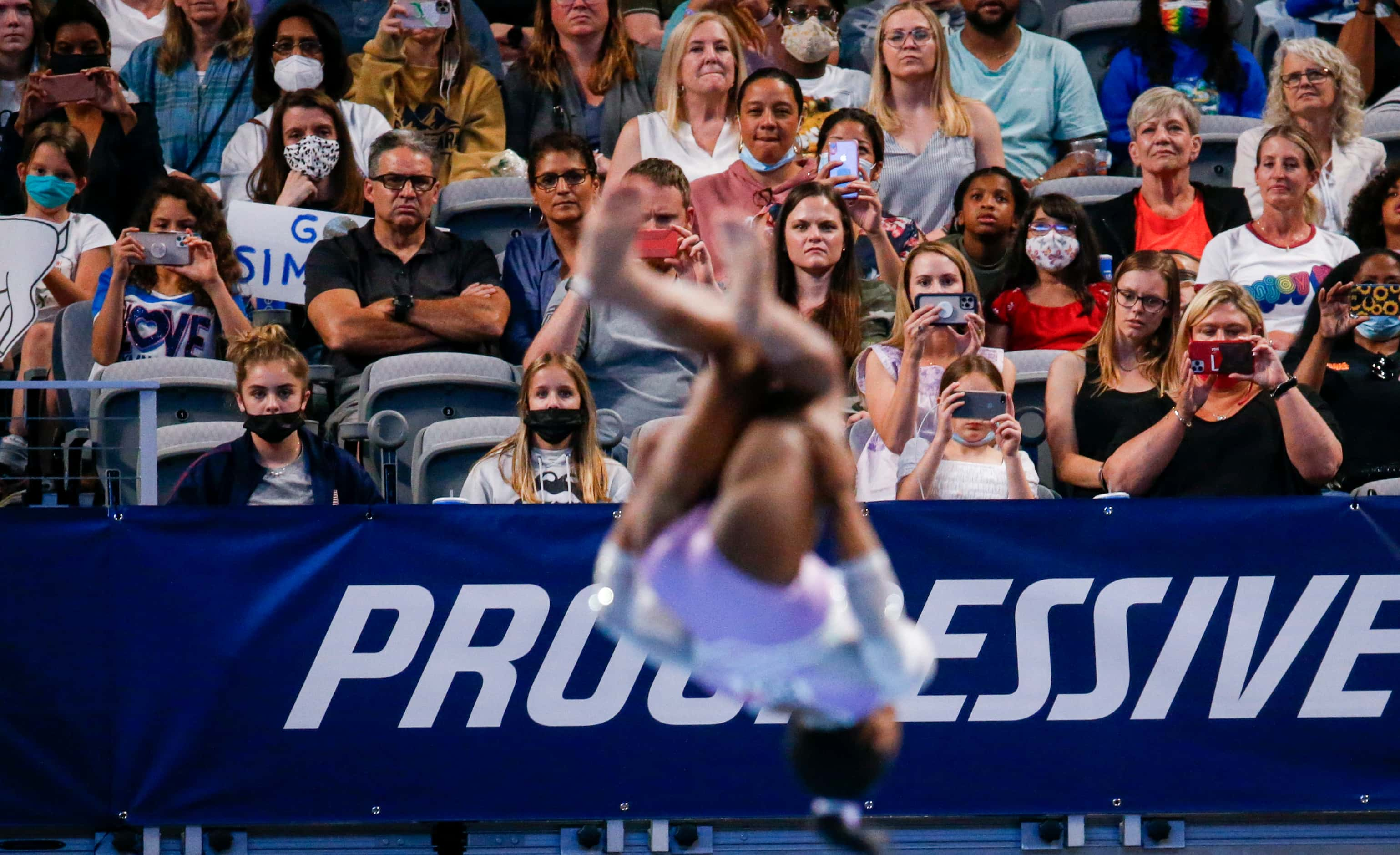 Fans watch Simone Biles perform on the floor during day 1 of the senior women's US...