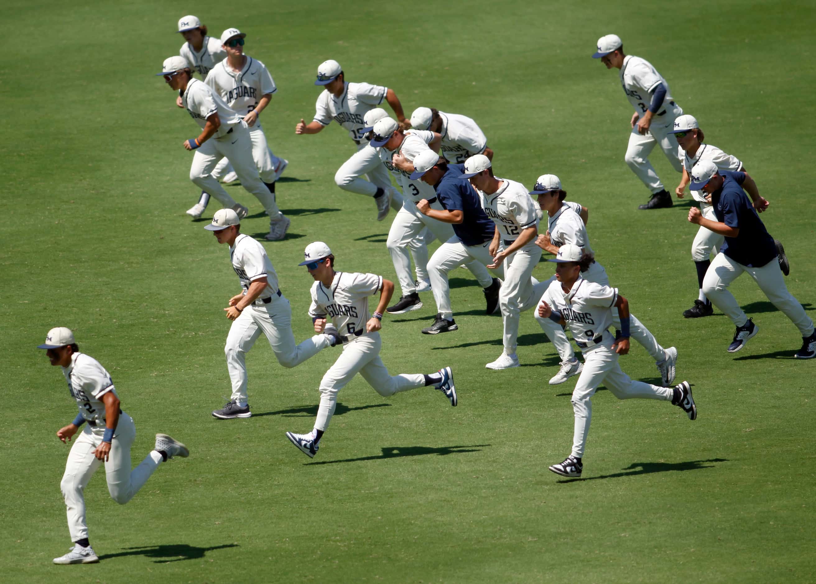 Flower Mound players and coaches run as part of their warm-up routine prior to the start of...