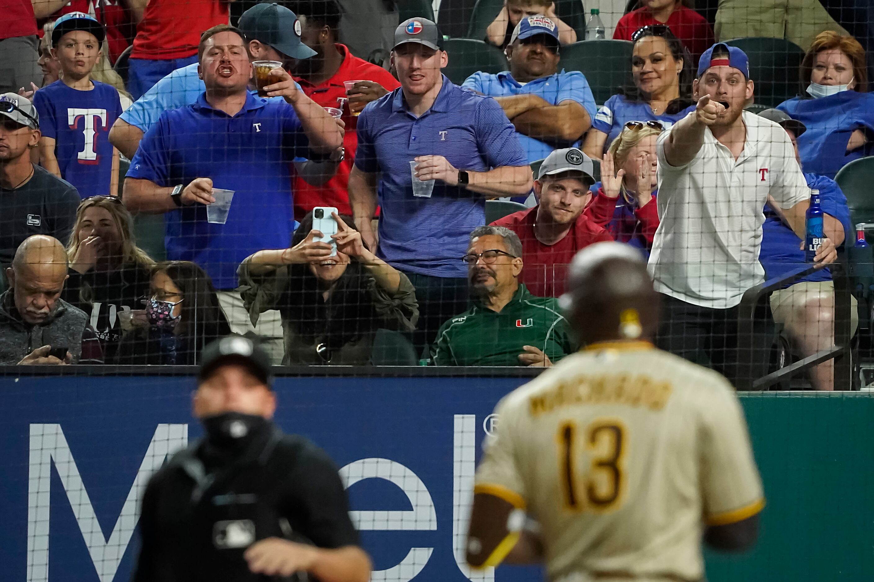 San Diego Padres' Manny Machado blows a gum bubble while watching