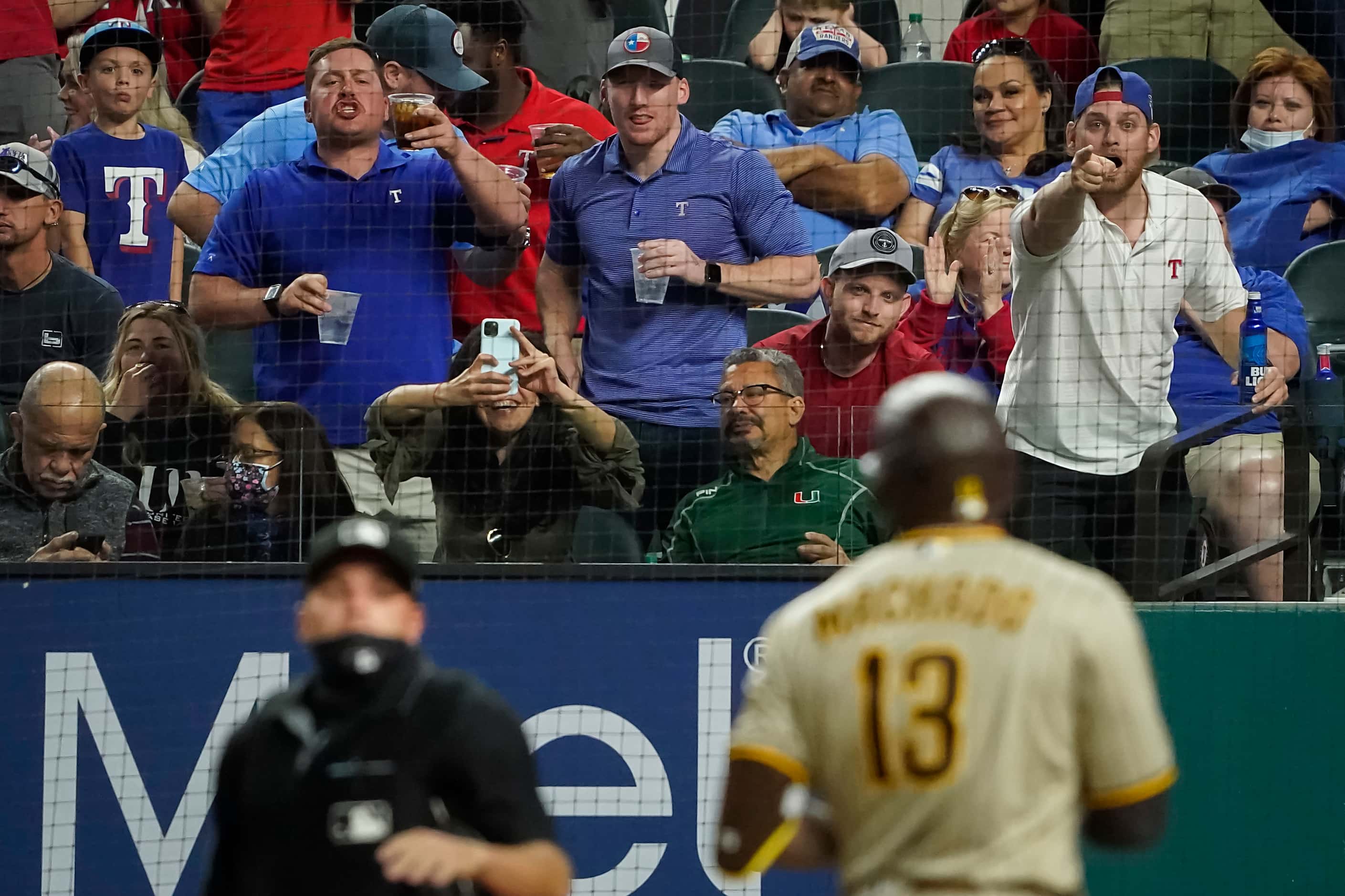 Texas Rangers fans heckle San Diego Padres third baseman Manny Machado after he struck out...
