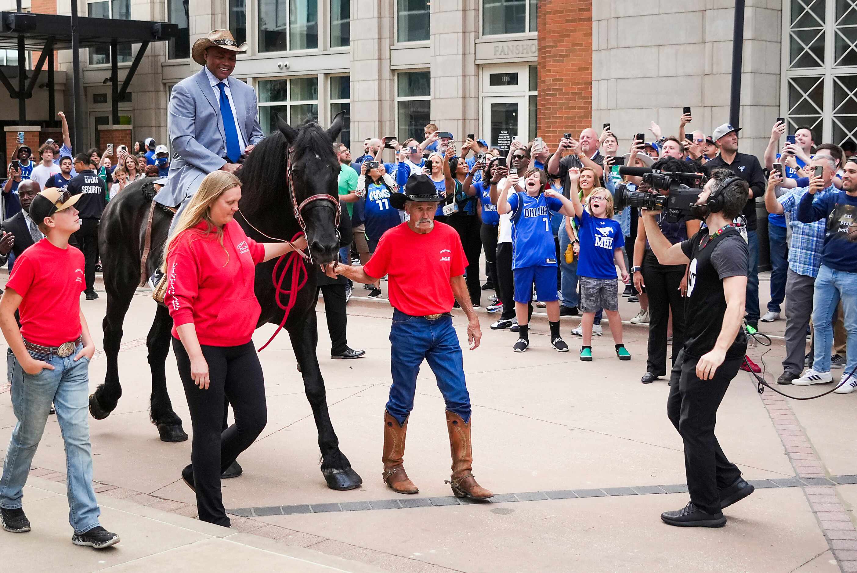 Charles Barkley arrives on horseback at the American Airlines Center as he makes his way to...