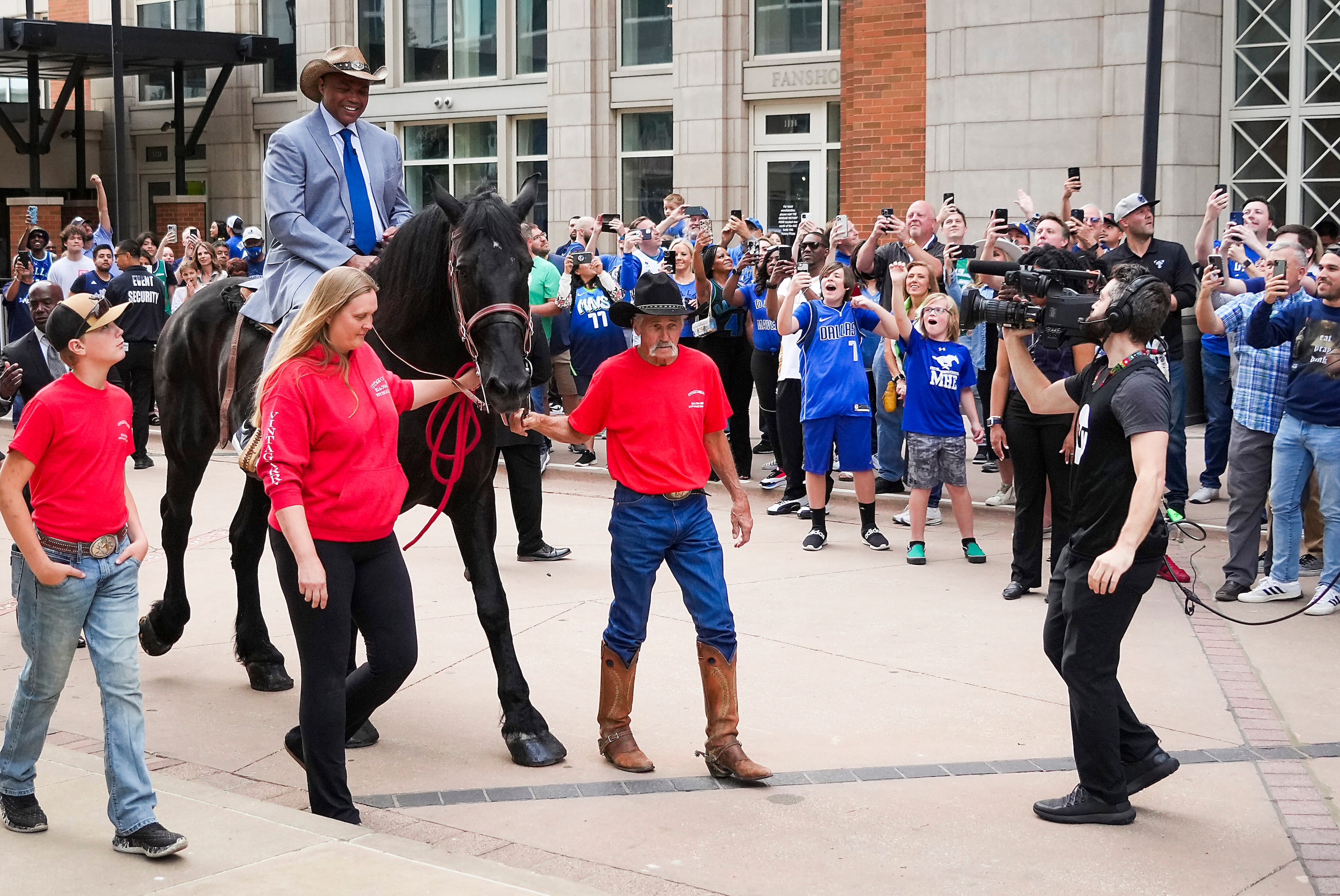 Charles Barkley arrives on horseback at the American Airlines Center as he makes his way to...