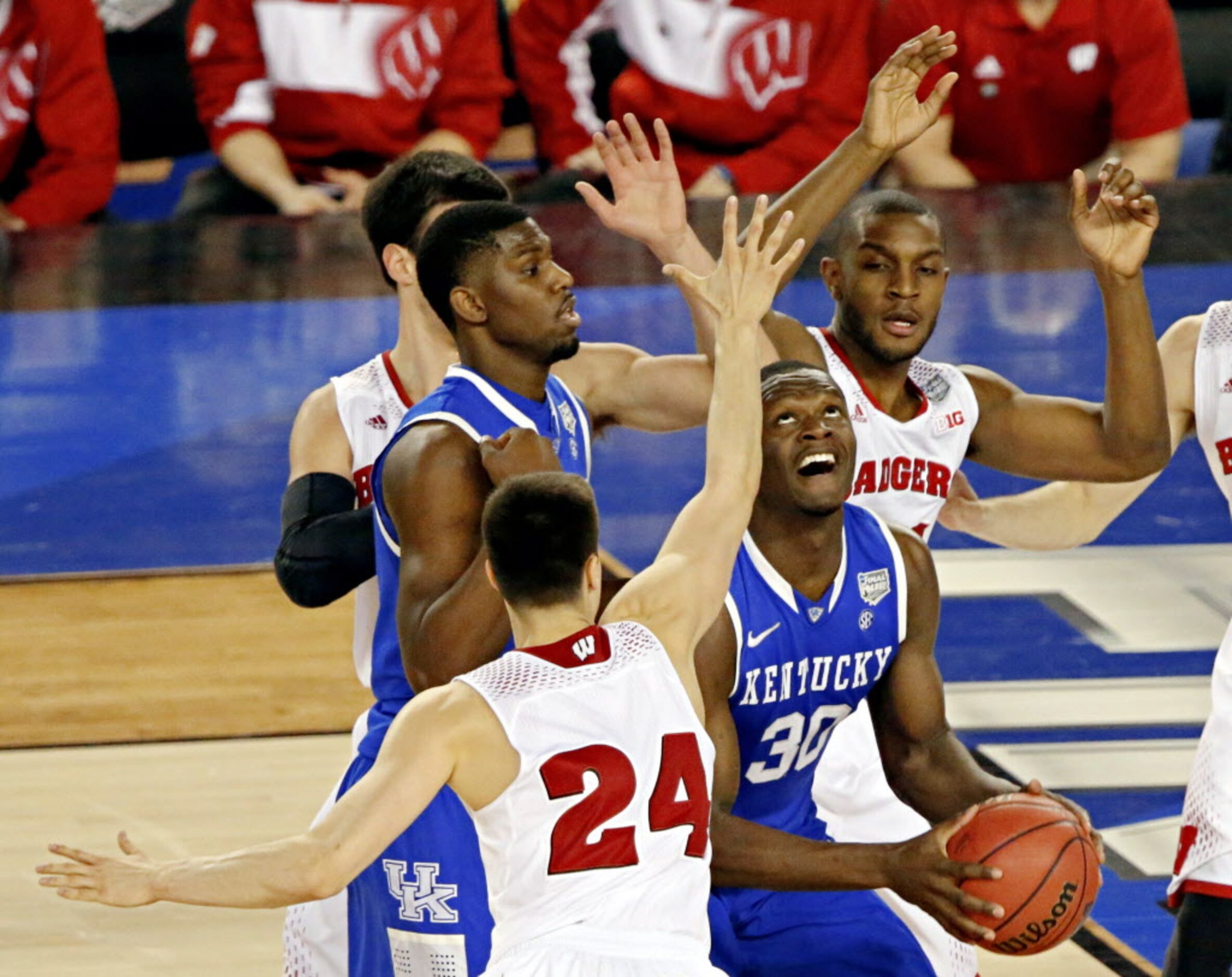 Kentucky Wildcats forward Julius Randle (30) goes up against Wisconsin Badgers guard Bronson...