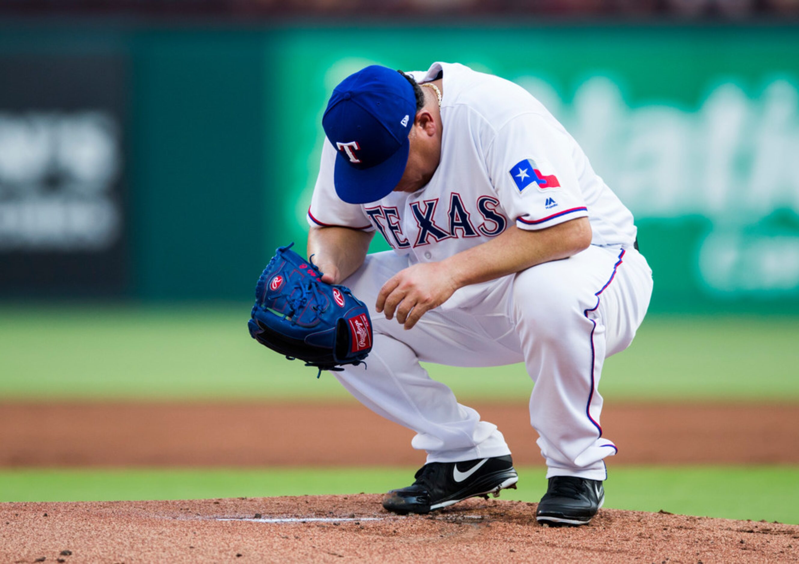 Texas Rangers starting pitcher Bartolo Colon (40) reacts to the Oakland Athletics scoring...