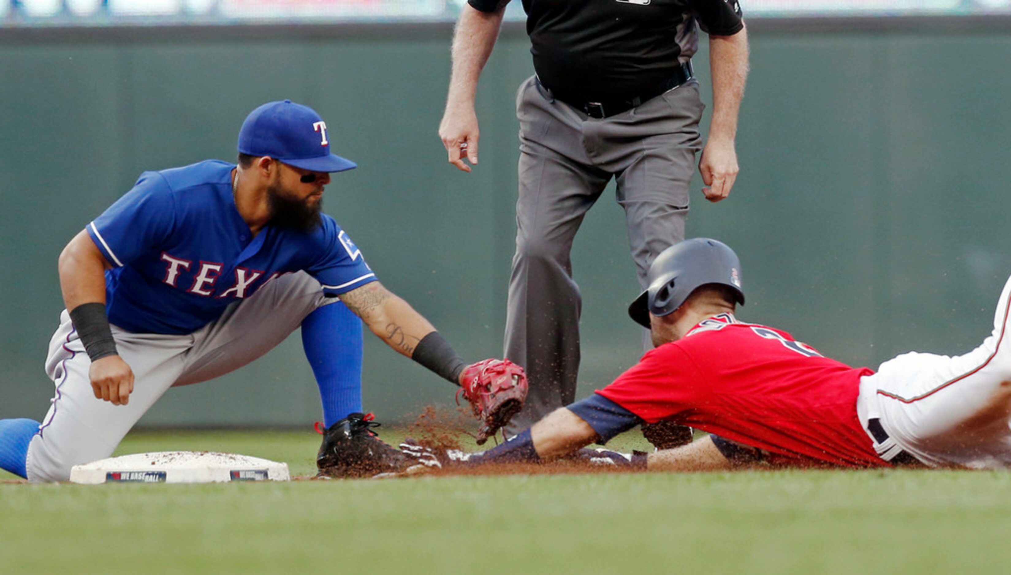 Minnesota Twins' Brian Dozier, right, is tagged out by Texas Rangers second baseman Rougned...