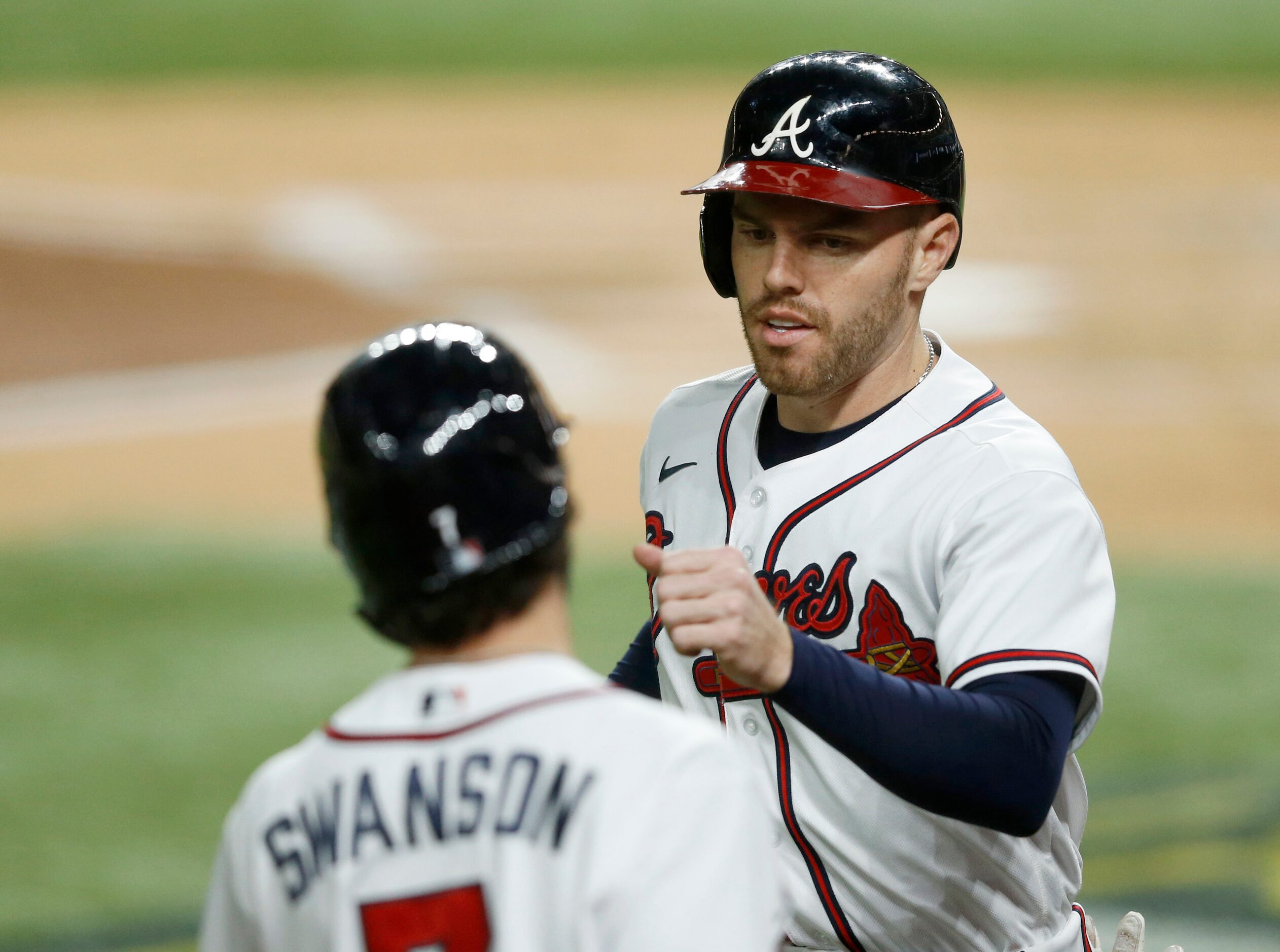 Atlanta Braves first baseman Freddie Freeman (5) celebrates a run scored with Atlanta Braves...