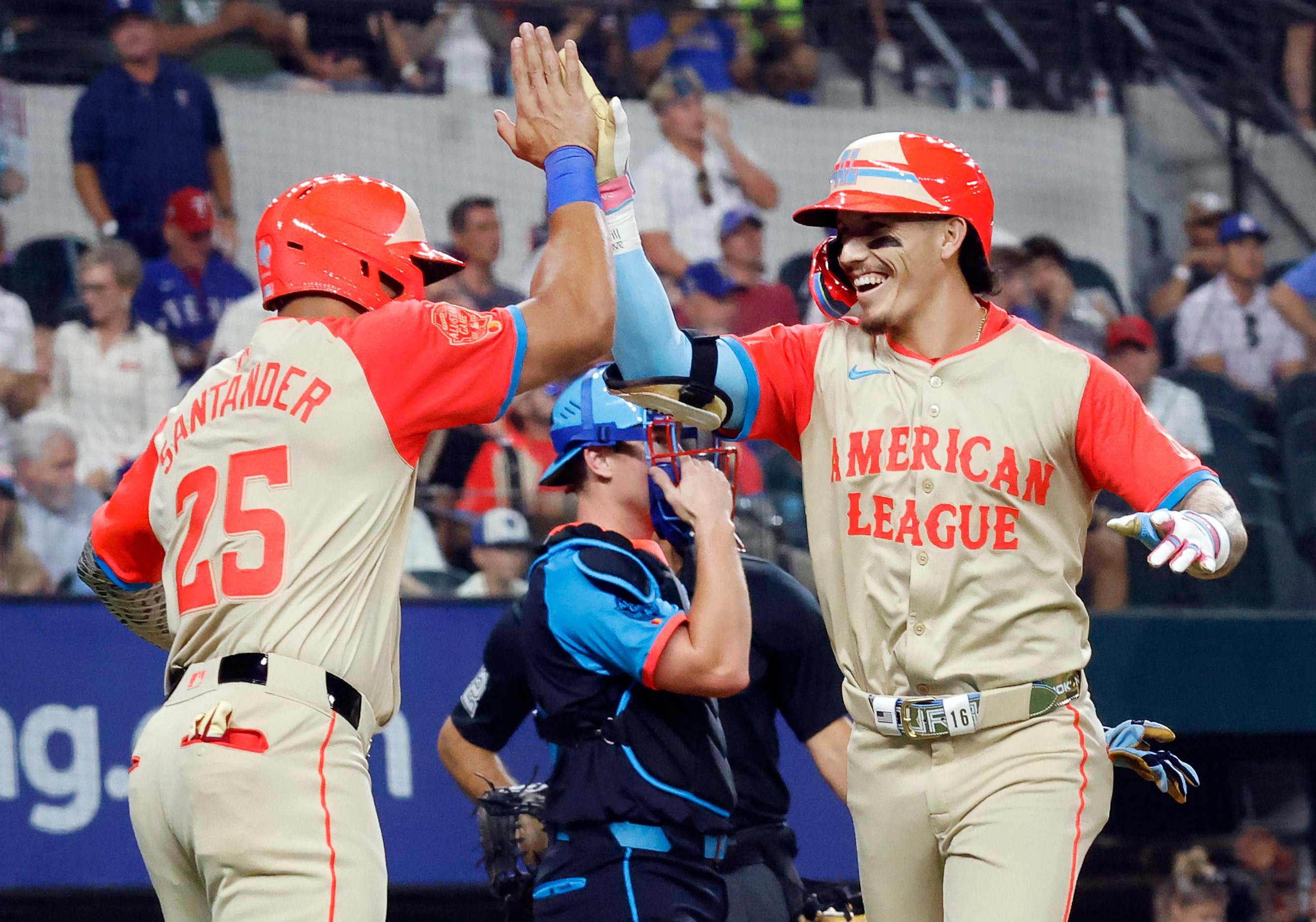 American League's Jarren Duran, of the Boston Red Sox, slaps hands with Anthony Santander,...