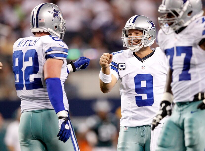 Dallas Cowboys quarterback Tony Romo (9) is all smiles with Dallas Cowboys tight end Jason...