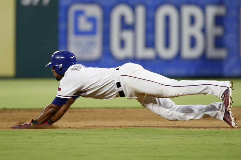 Texas Rangers shortstop Elvis Andrus (1) slides into second in the second inning at Globe...
