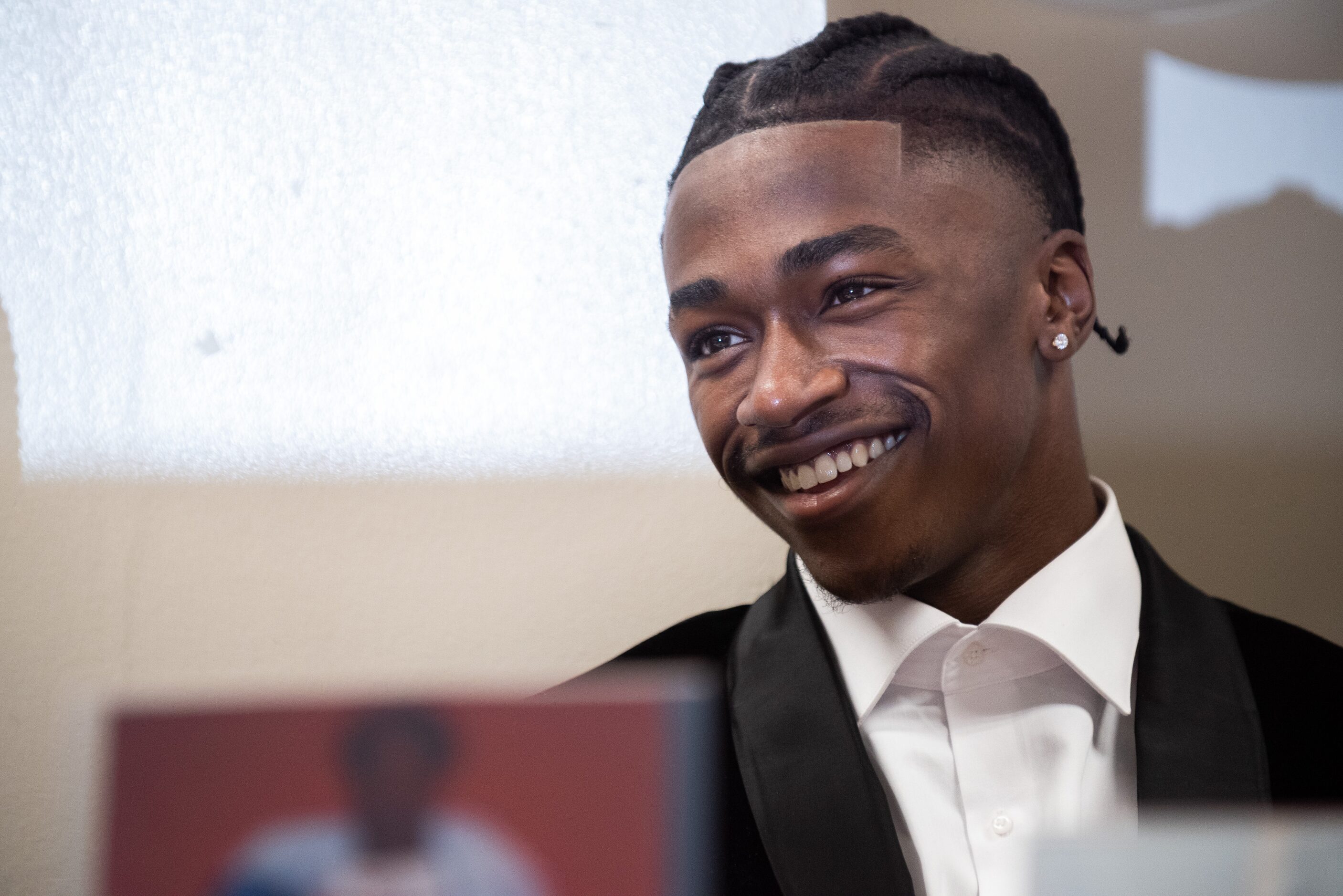 DeSoto high school football player Johntay Cook II reacts with a smile as he listens to a...