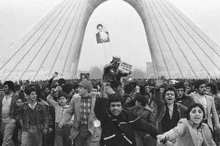 In this Feb. 8, 1979 file photo, an Iranian soldier is carried by supporters of Ayatollah...