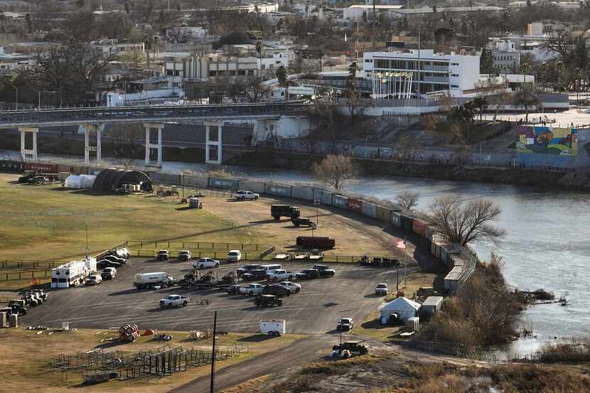 Shipping containers and concertina wire line the banks of the Rio Grande in Shelby Park in...