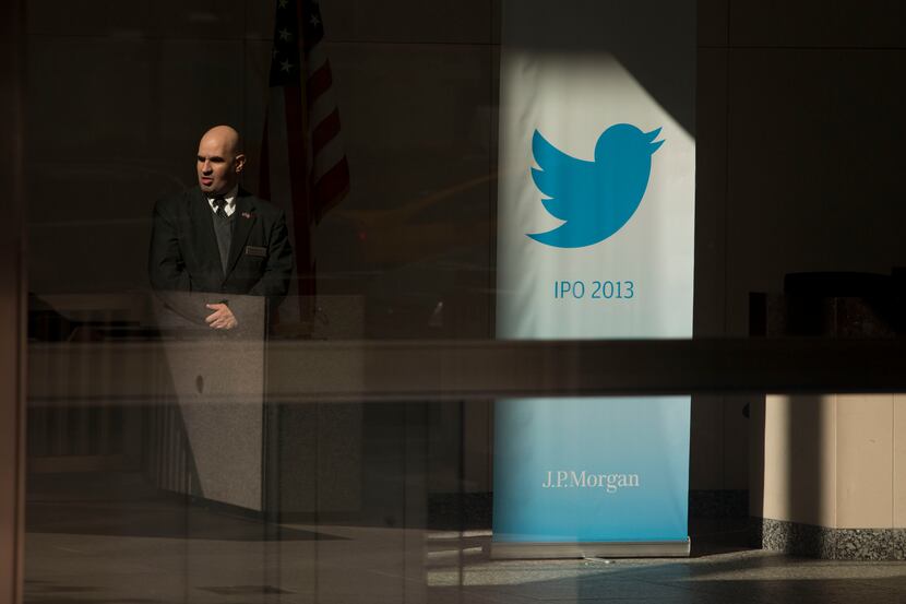 Bloomberg Photo Service 'Best of the Week': A security guard stands next to the Twitter Inc....