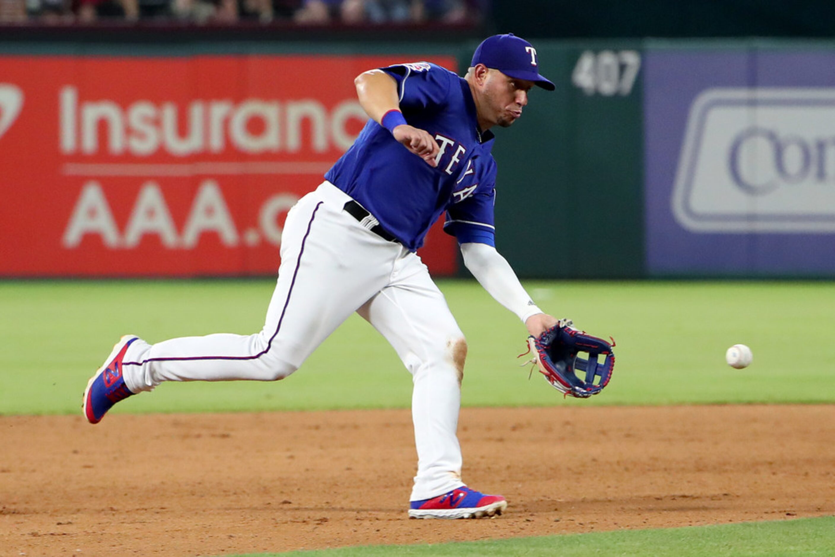 ARLINGTON, TEXAS - JUNE 22: Asdrubal Cabrera #14 of the Texas Rangers fields a ground ball...