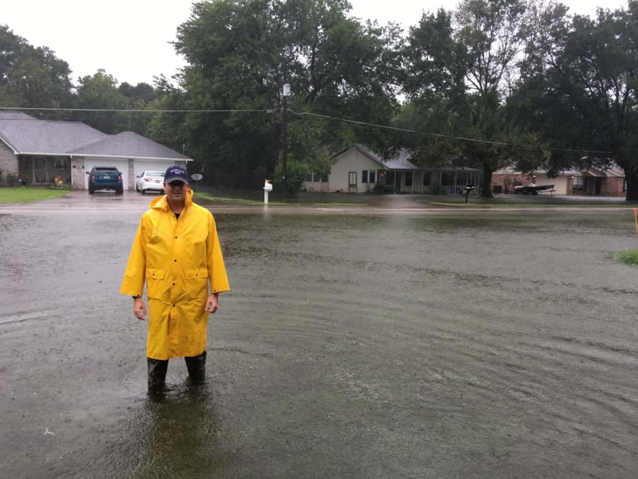 Mayor Scott Saunders of Smithville stands in the front yard of his grandparents' home, the...