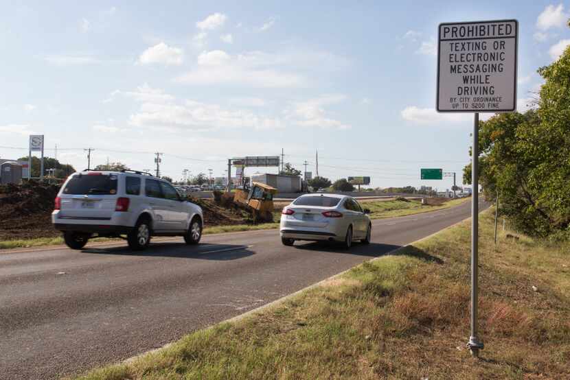 A warning sign about texting while driving is seen near northbound Interstate 35 and...