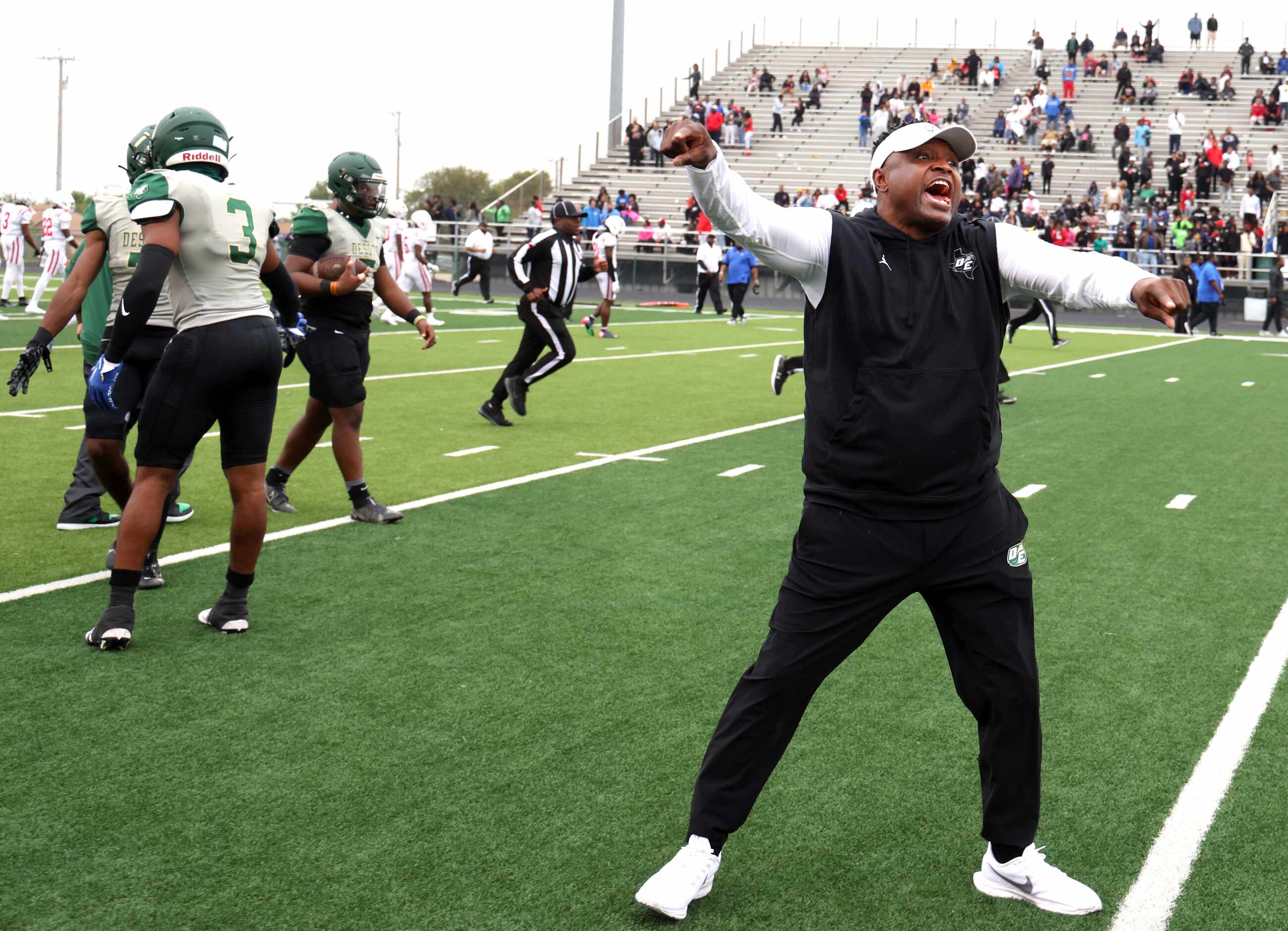 DeSoto Eagles head coach Claude Mathis directs his players to stay in the team bench area at...