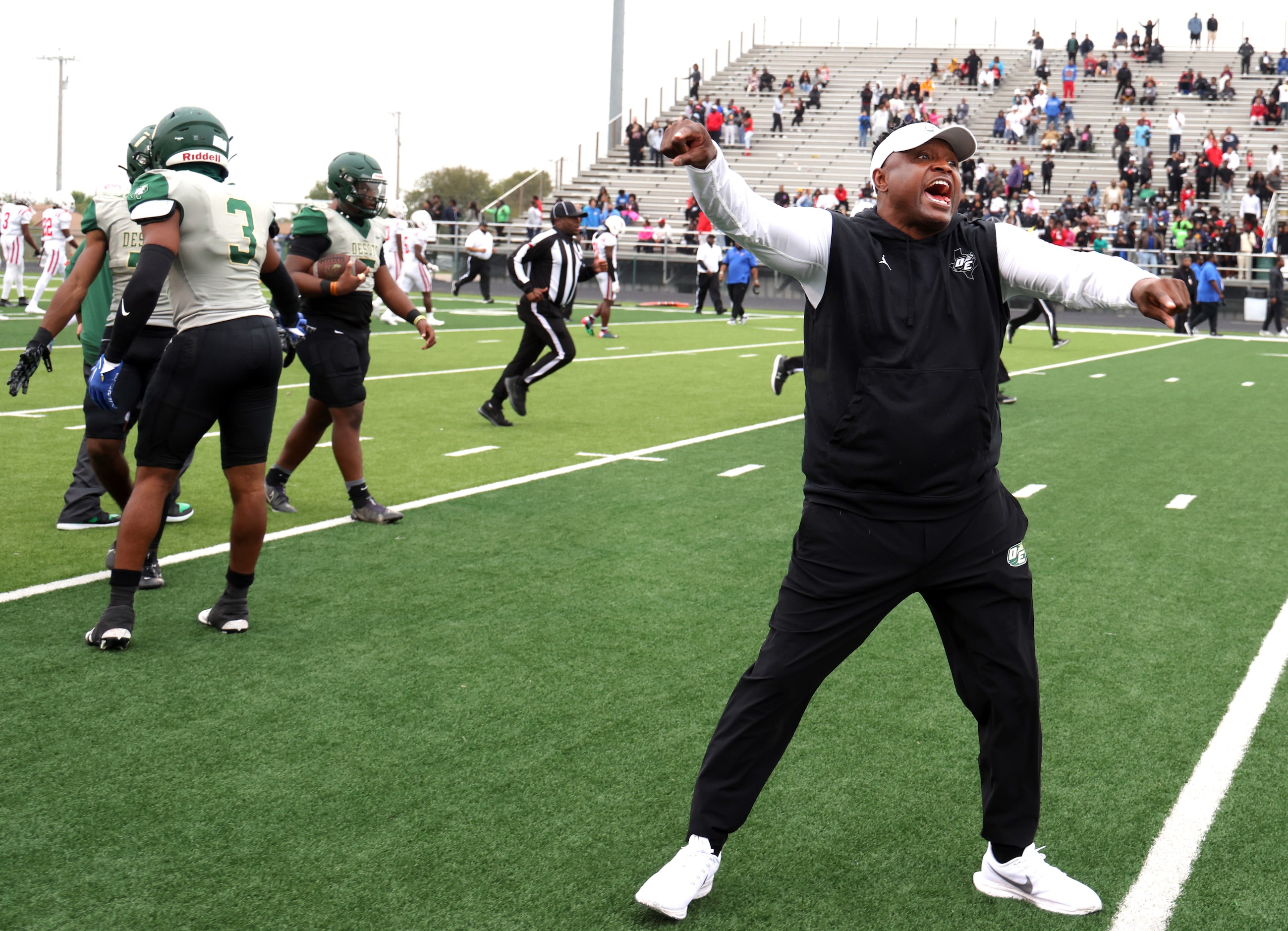 DeSoto Eagles head coach Claude Mathis directs his players to stay in the team bench area at...