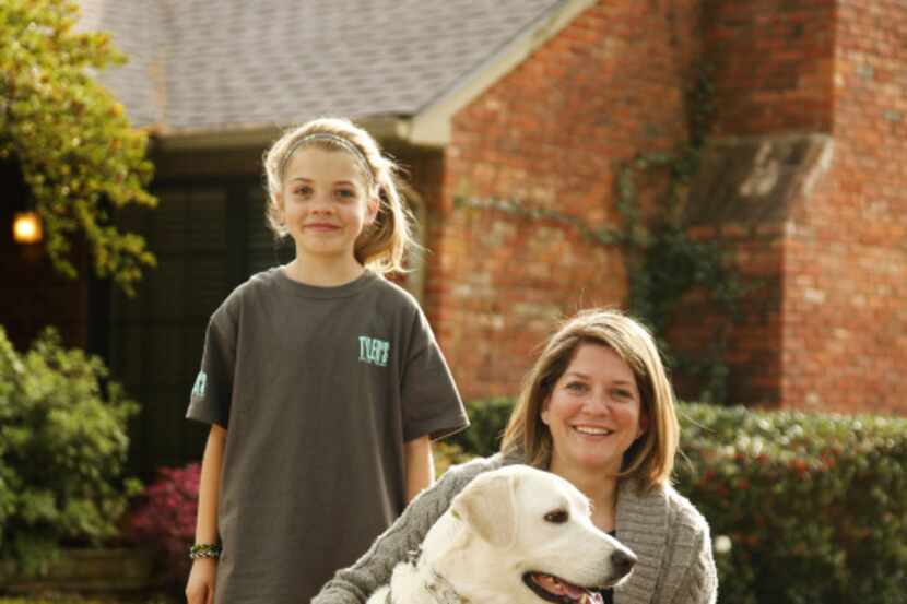 Dallas residents Addison Higgins (left), 9, and her mother, Amy, with their dog, Wrigley,...