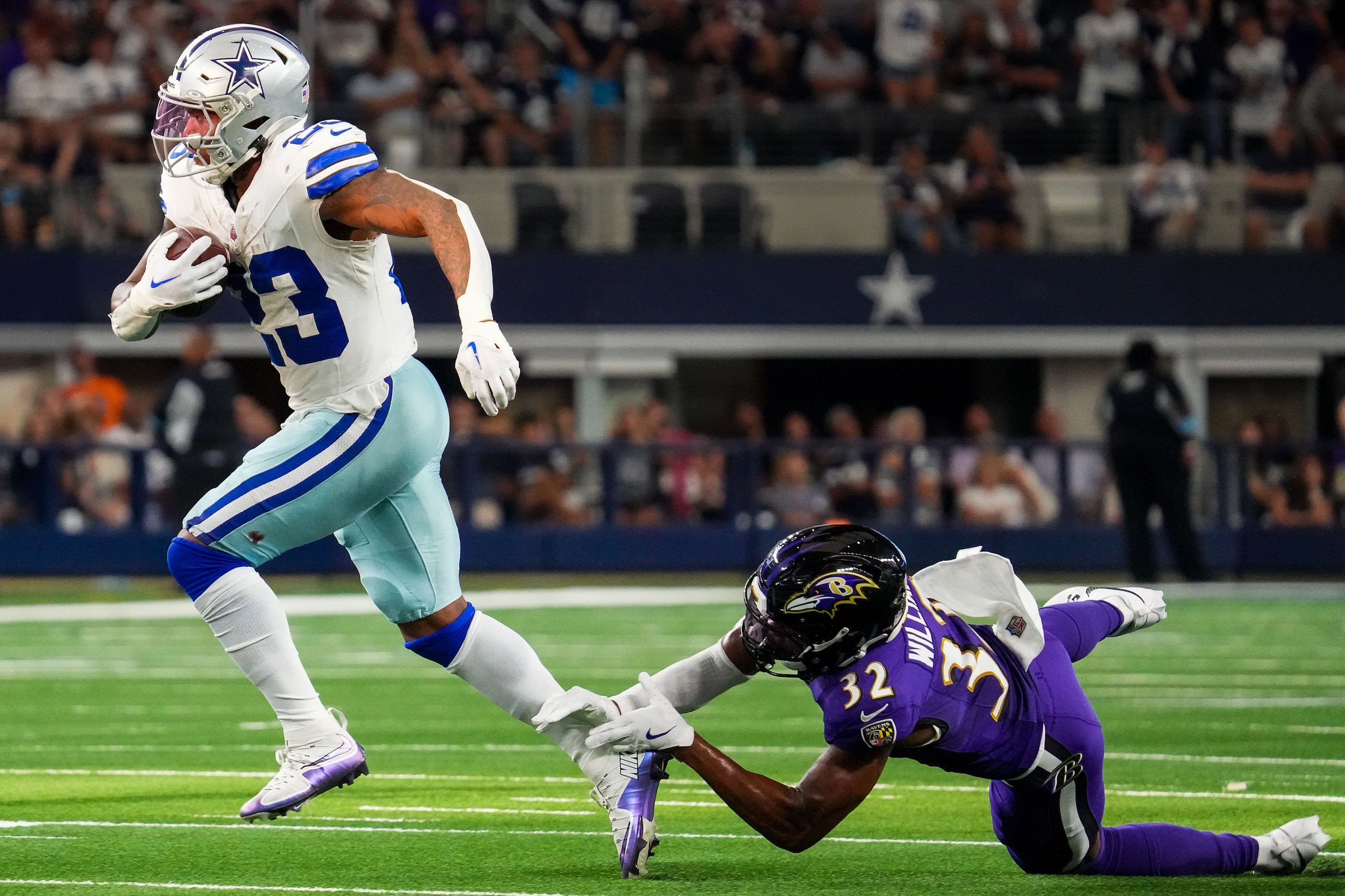 Dallas Cowboys running back Rico Dowdle (23) gets past Baltimore Ravens safety Marcus...