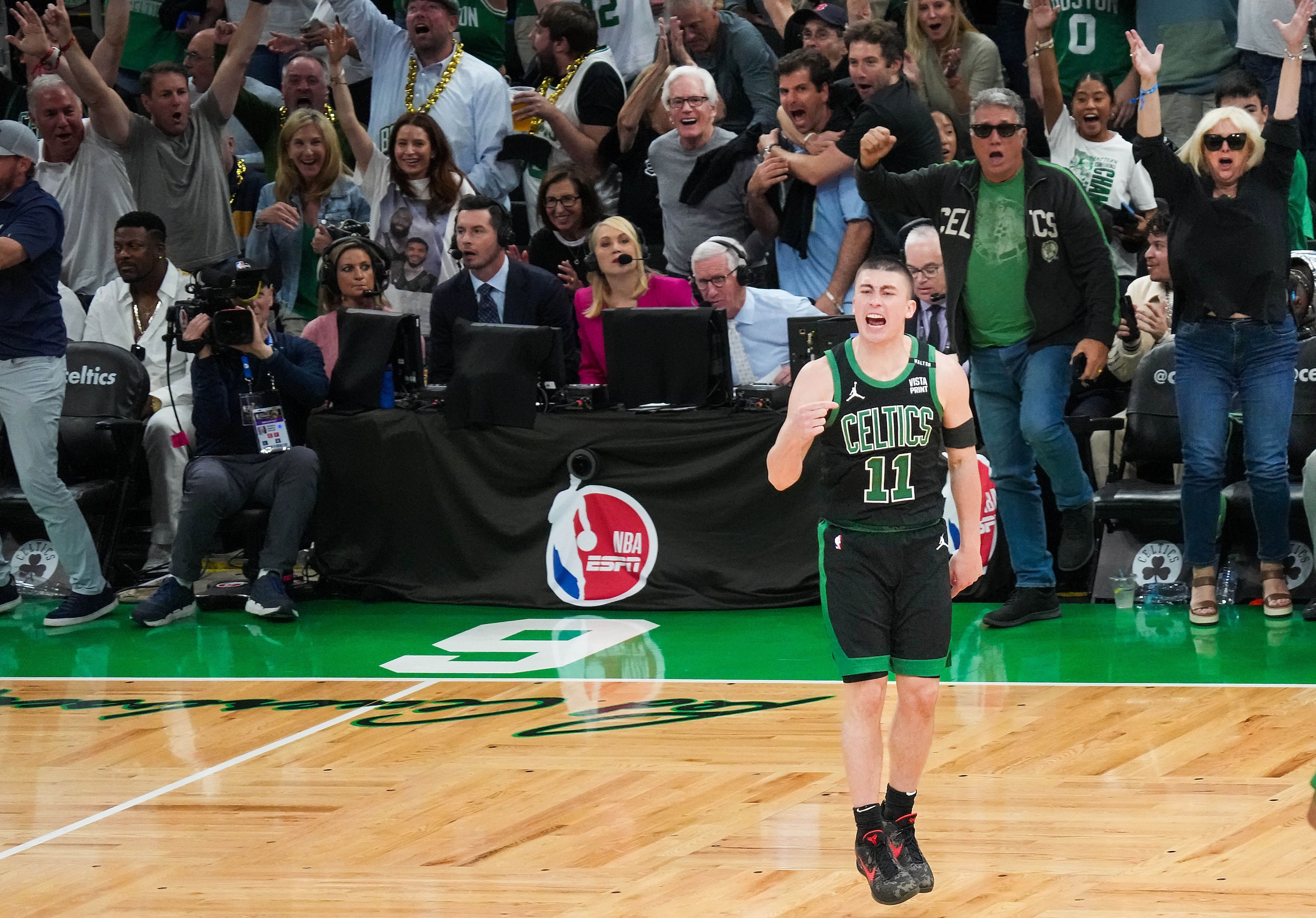 Boston Celtics guard Payton Pritchard celebrates after hitting a 3-point buzzer-beater at...