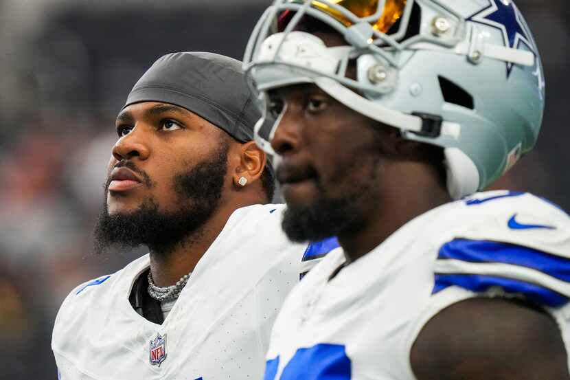 Dallas Cowboys linebacker Micah Parsons (11) and defensive end Demarcus Lawrence (90) watch...