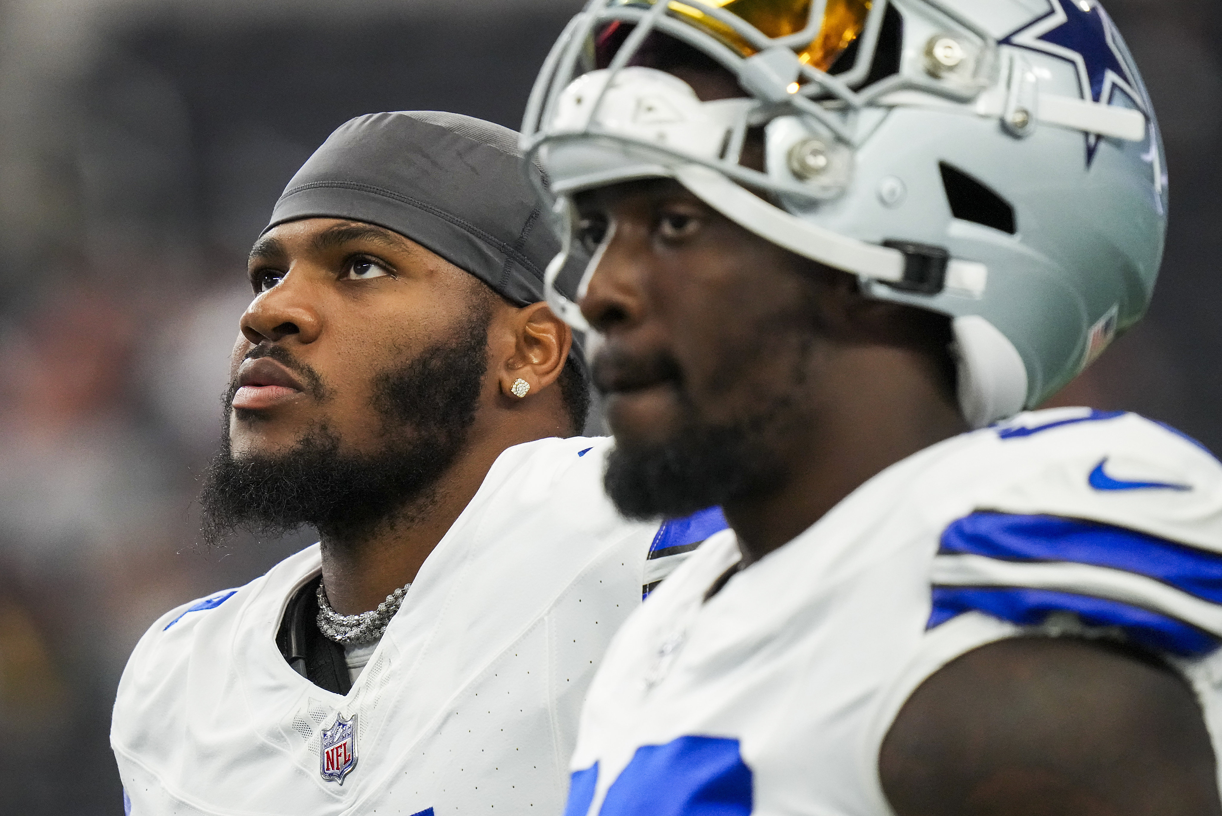 Dallas Cowboys linebacker Micah Parsons (11) and defensive end Demarcus Lawrence (90) watch...