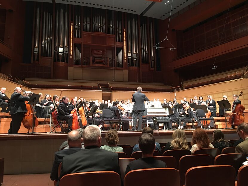 Concertmaster James Andrewes tunes the orchestra for the Dallas Bach Society's performance...