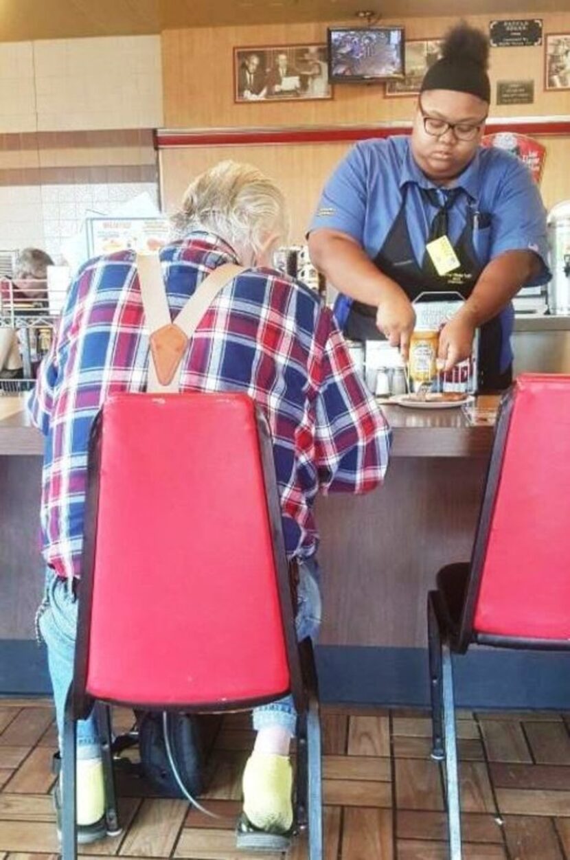 Evoni Williams, 18, helps a customer in La Marque Waffle House.