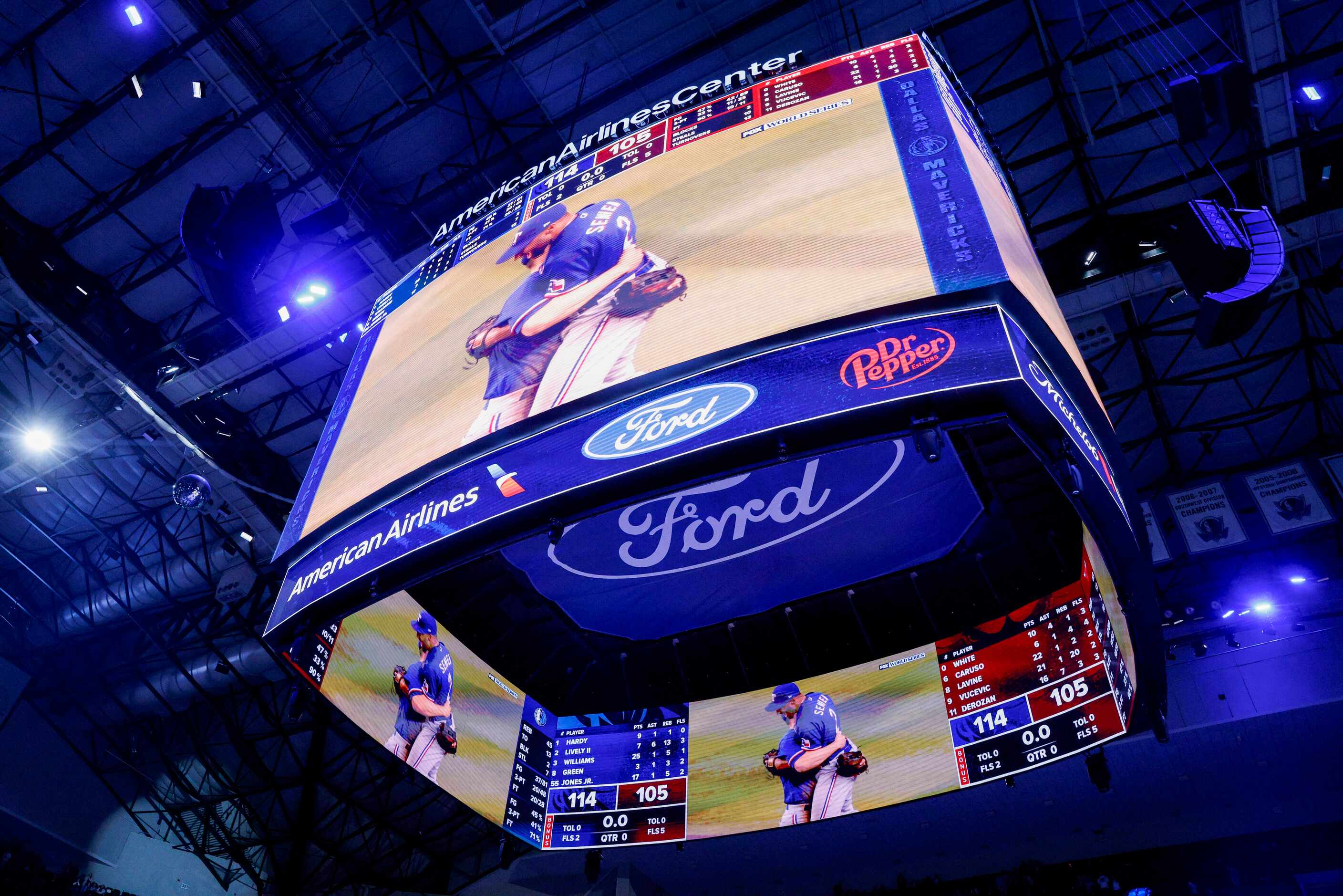 The Jumbotron at the American Airlines Center shows the Texas Rangers celebrating their...