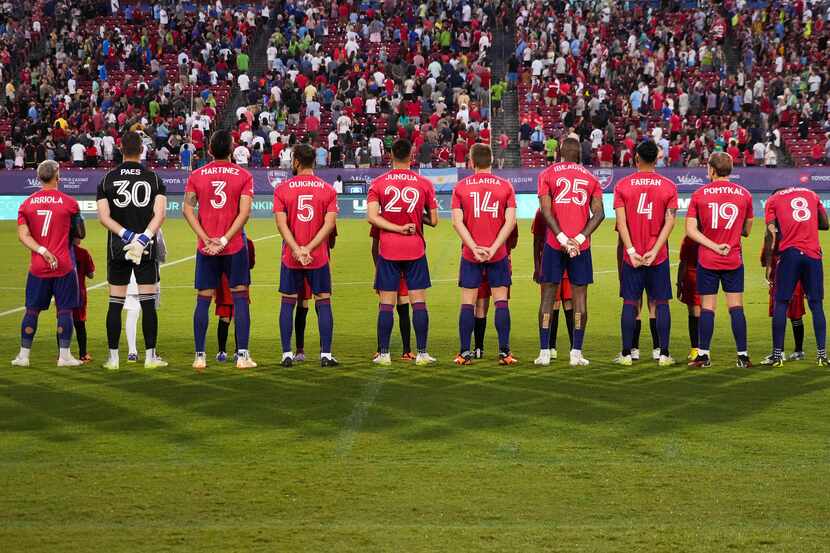 FC Dallas player stand for the national anthem before an MLS soccer game against the Seattle...