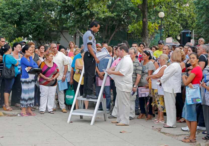 
Cubans applying for U.S. visas waited Wednesday for their name to be called by an employee...