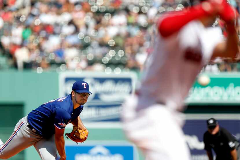 Texas Rangers pitcher Dane Dunning, left, delivers to Boston Red Sox' Xander Bogaerts,...