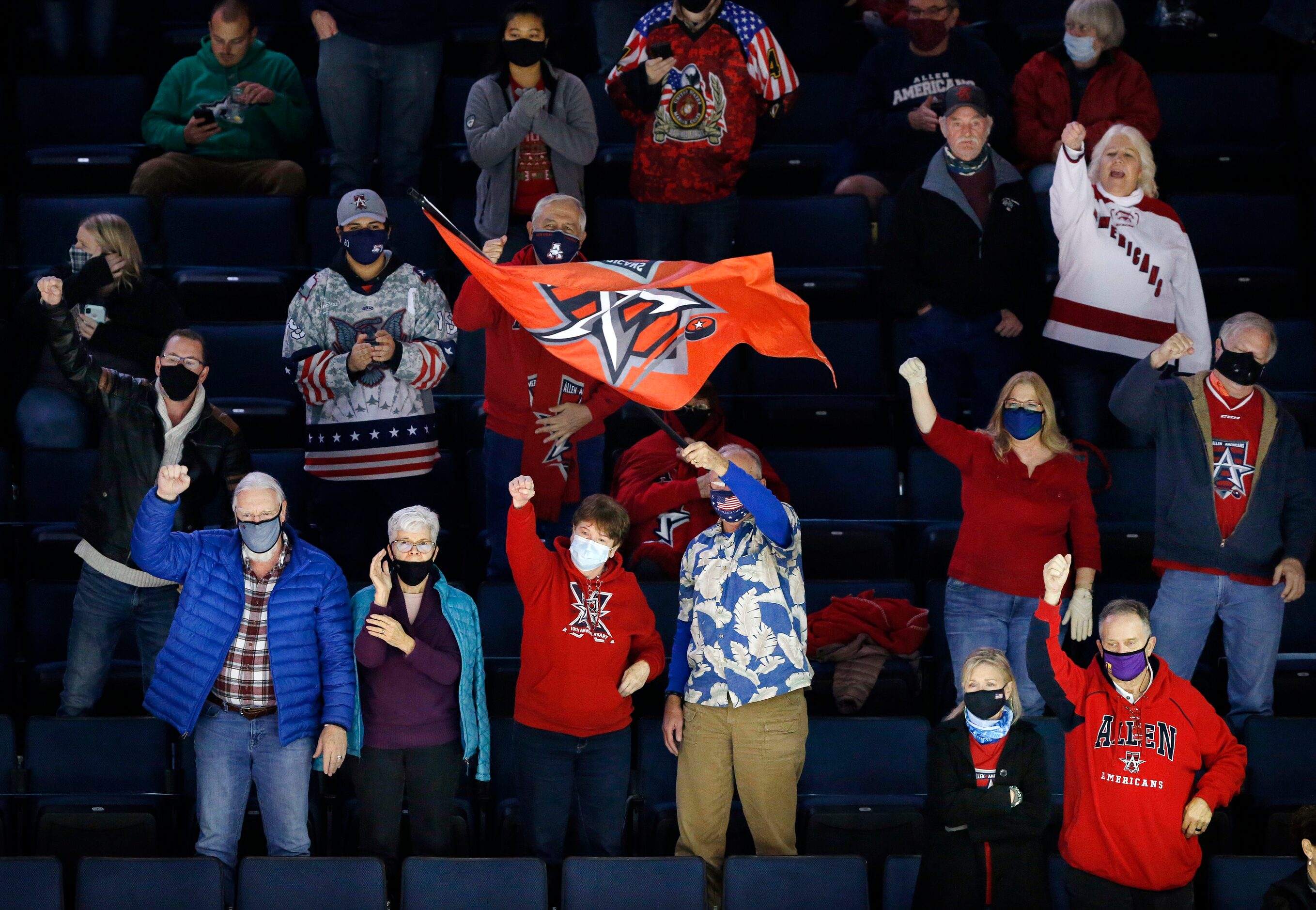 Allen Americans hockey fans celebrate a first period goal during their game against Rapid...