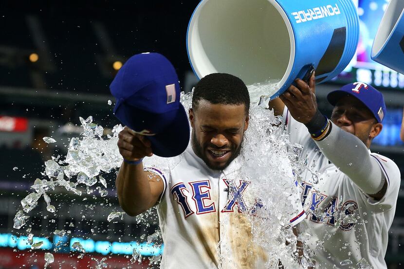 ARLINGTON, TX - SEPTEMBER 11:  Delino DeShields #3 of the Texas Rangers gets showered with...