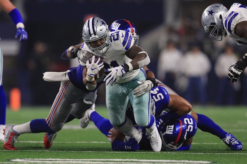 ARLINGTON, TX - SEPTEMBER 10:  Ezekiel Elliott #21 of the Dallas Cowboys is tackled by  B.J....