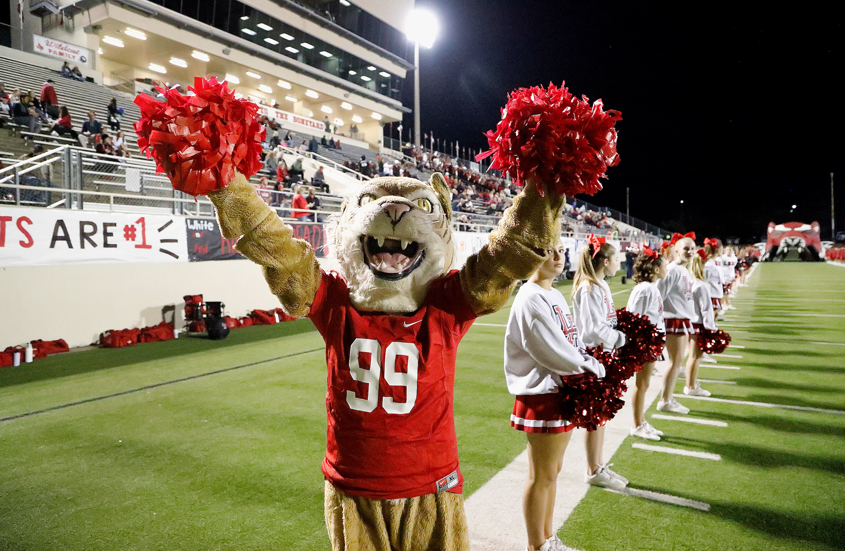 The Freshman Wildcat, Grace Brennan, 14, waits for her team to take the field before kickoff...