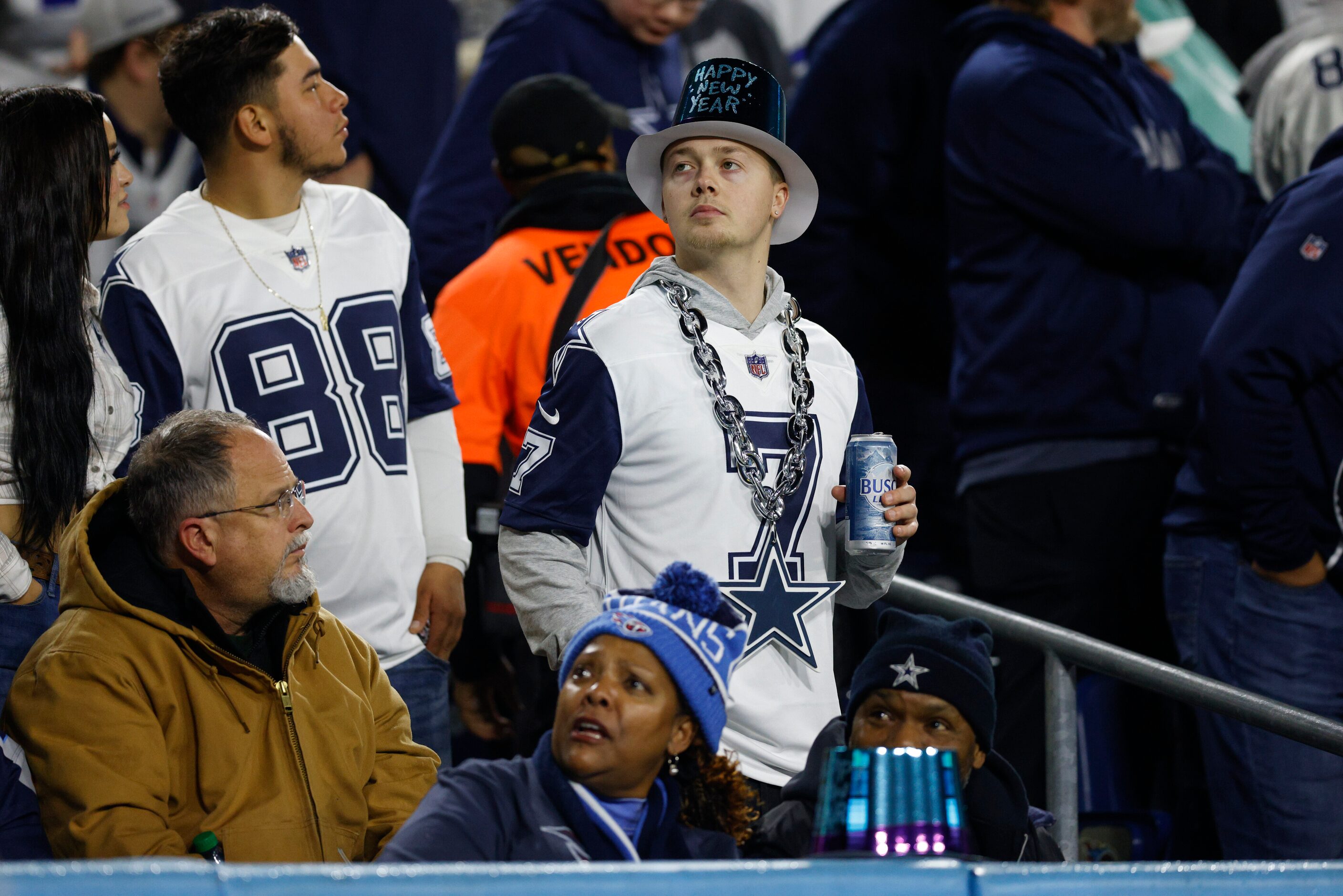 A Dallas Cowboys fan wears a Happy New Year hat during the first half of an NFL game against...