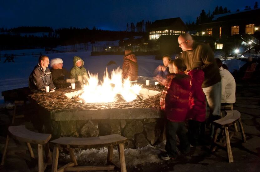 Folks around the fire on the deck behind Heck's Tavern, moonlight ski night, at Devil's...