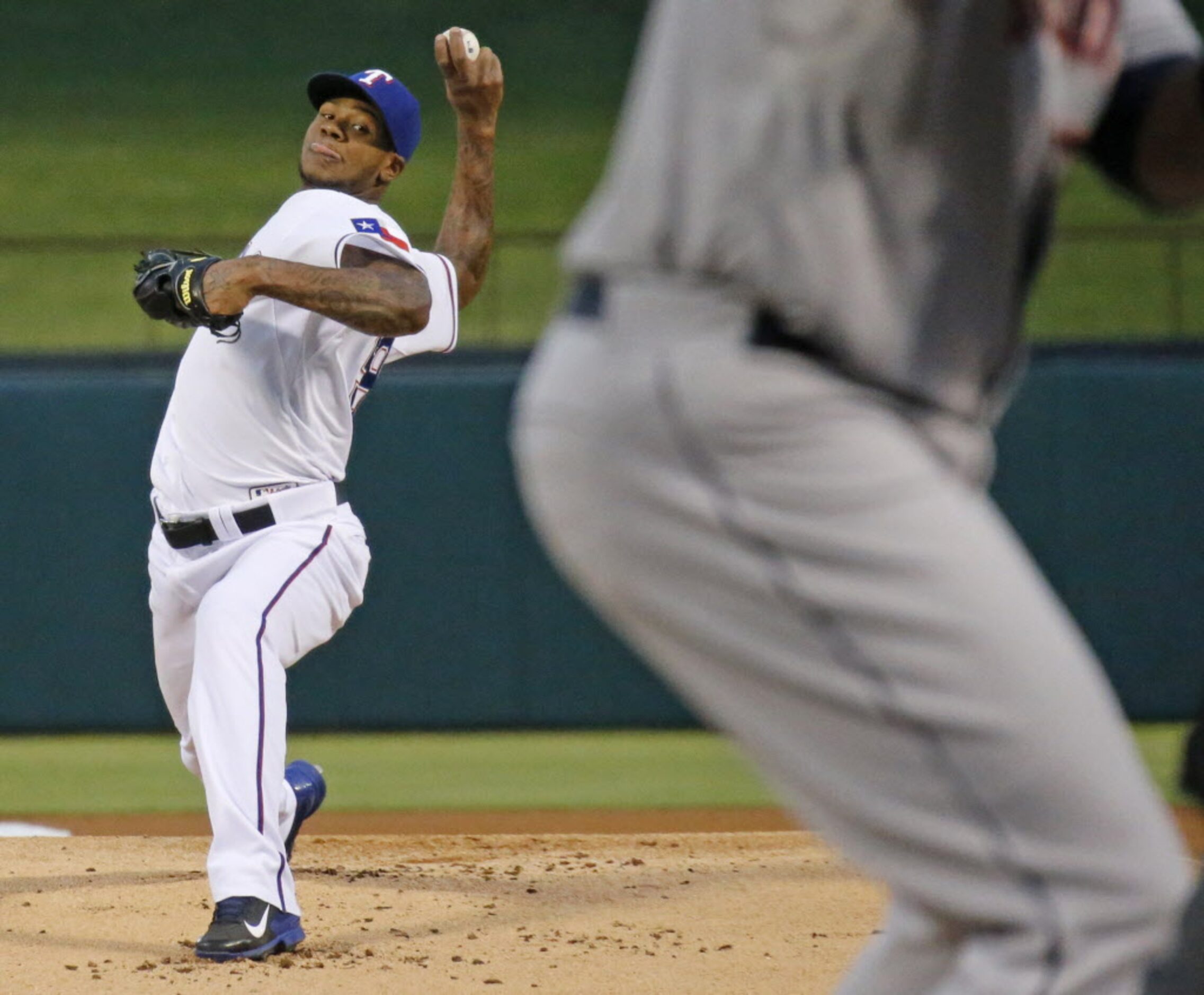 Texas starting pitcher Lisalverto Bonilla throws a first-inning pitch to Houston's Chris...