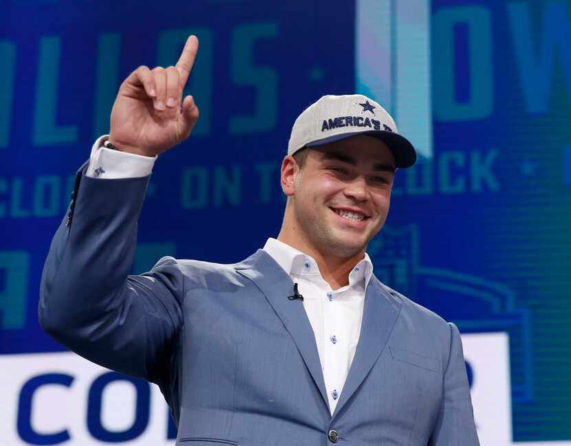 Connor Williams gestures toward the crowd after being selected by the Cowboys in the second...