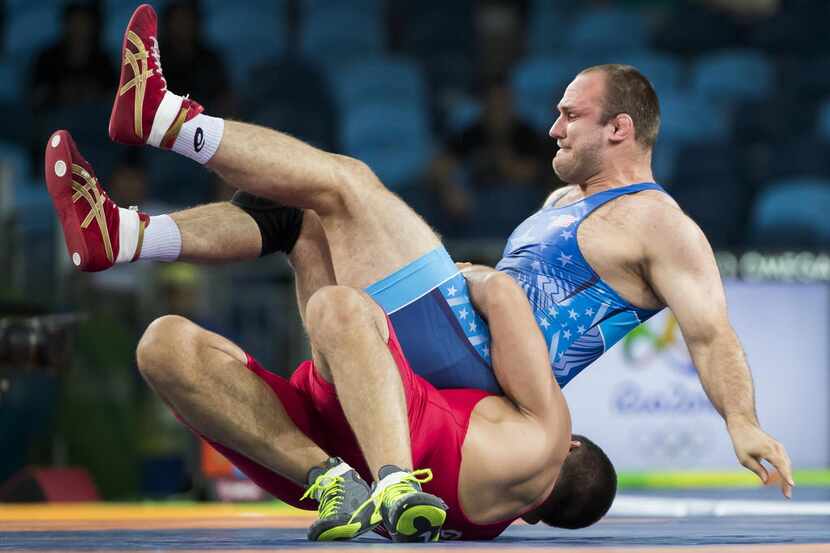 Tervel Dlagnev of the USA (in blue) wrestles against Geno Petriashvili of Georgia for the...