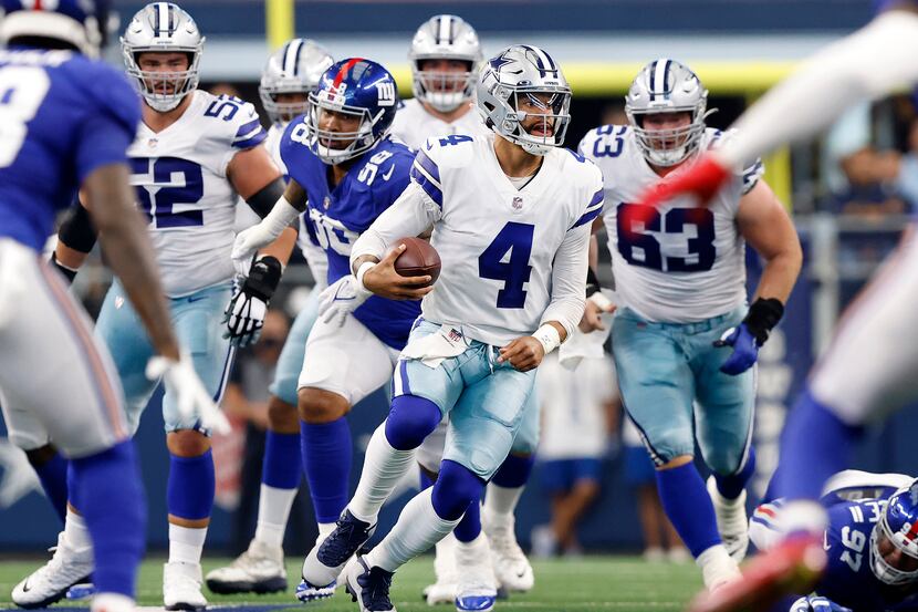 Dallas Cowboys quarterback Dak Prescott (4) races through a big hole in the line in the...
